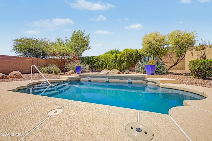 Desert landscaped backyard with a pool.