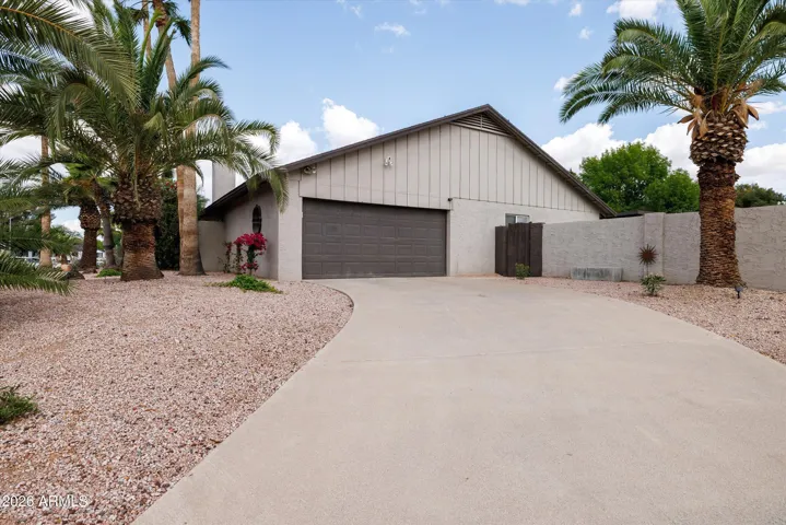 Long driveway to 2 car garage and backyard gate.