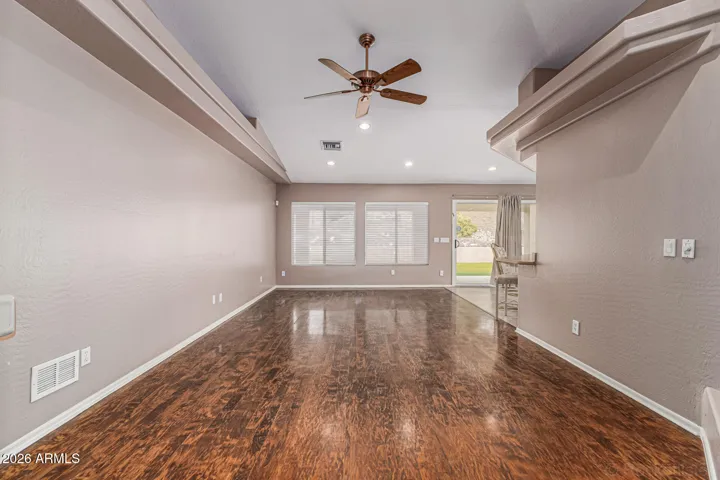 Wood floors with planation shutters and large living space.