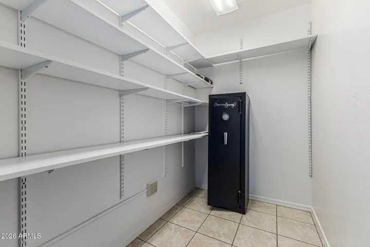 His and hers primary closet with safe
