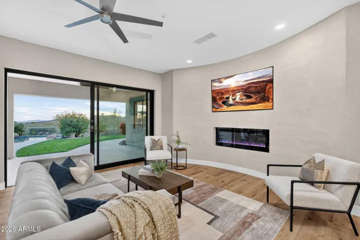 Stylish living space with contemporary finishes, ceiling fan, and direct patio access, showcasing Scottsdale indoor-outdoor flow and modern design.
