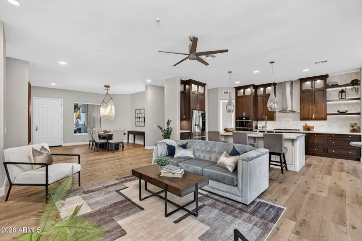 Spacious open-concept design connecting the living room, dining area, and chef’s kitchen, showcasing Scottsdale indoor-outdoor flow and upgraded finishes.