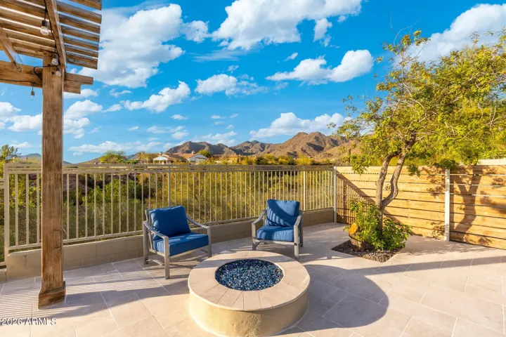 Scottsdale patio featuring a modern fire pit and seating area with breathtaking mountain views, ideal for relaxing evenings outdoors.