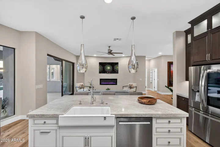 Spacious kitchen island with bar seating, pendant lighting, and ample prep space, ideal for entertaining in this beautifully updated Scottsdale home.