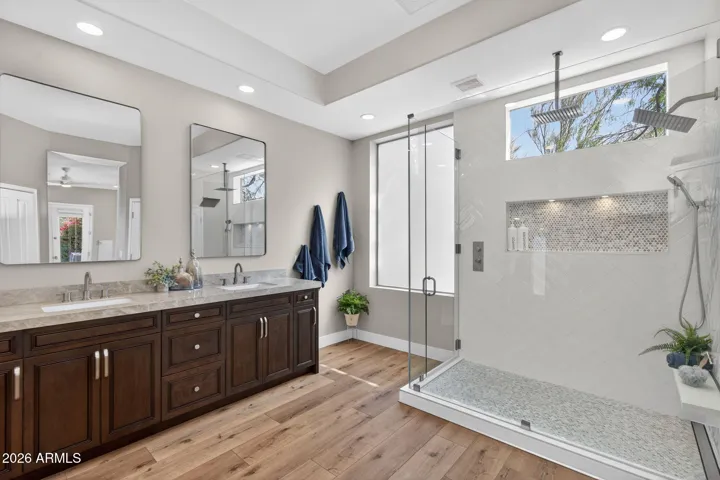 Spa-inspired Scottsdale bathroom featuring a large glass shower, designer tile, and rainfall showerhead, creating a relaxing and modern retreat.