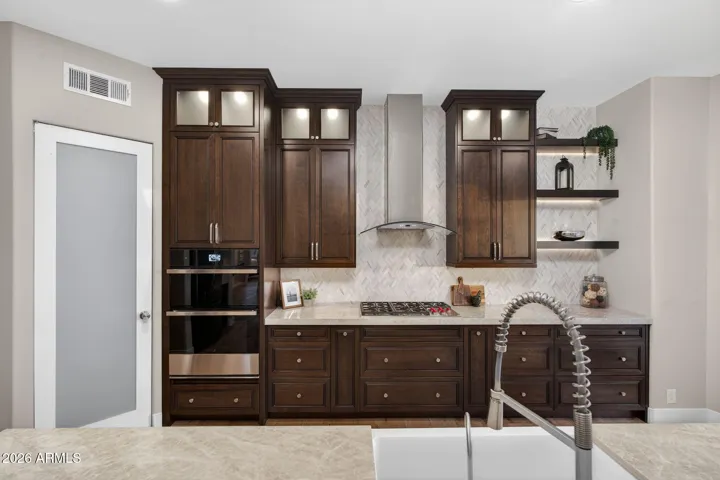 Upgraded Scottsdale kitchen with custom cabinetry, built-in appliances, gas cooktop, and modern finishes designed for both functionality and style.