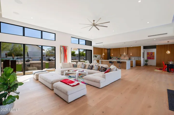 Bright front living space with large windows, modern finishes, and open connection to the kitchen. This Paradise Valley home showcases stylish design and functional layout.