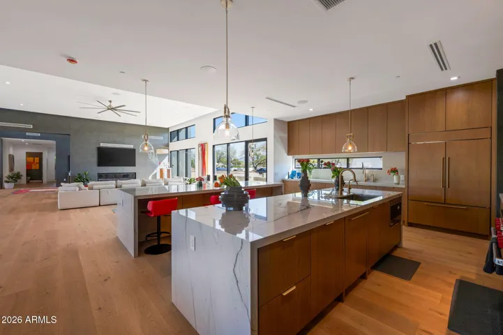 High-end kitchen with dual islands, quartz surfaces, and seamless connection to living areas. This Paradise Valley home features modern upgrades and open-concept design.