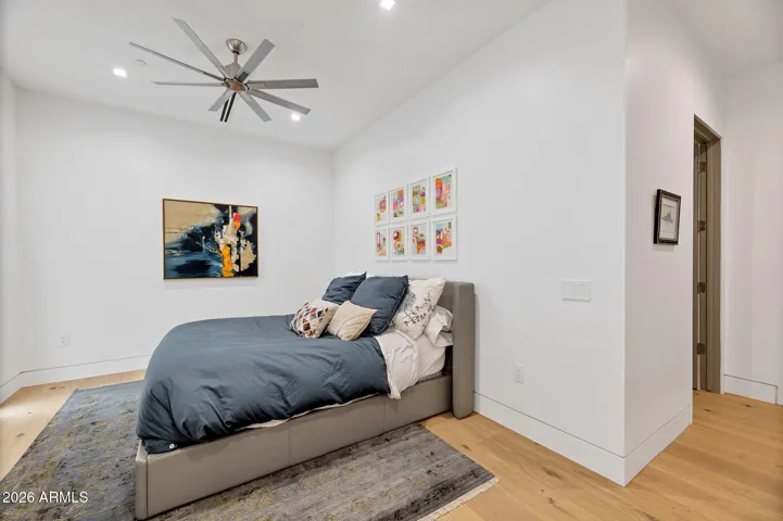 3rd bedroom with clean lines, wood flooring, and bright lighting. This Paradise Valley home offers versatile living space ideal for guests or a home office.