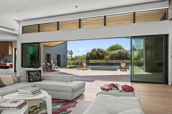 Seamless indoor outdoor experience from the living room to the large covered patio to the resort pool