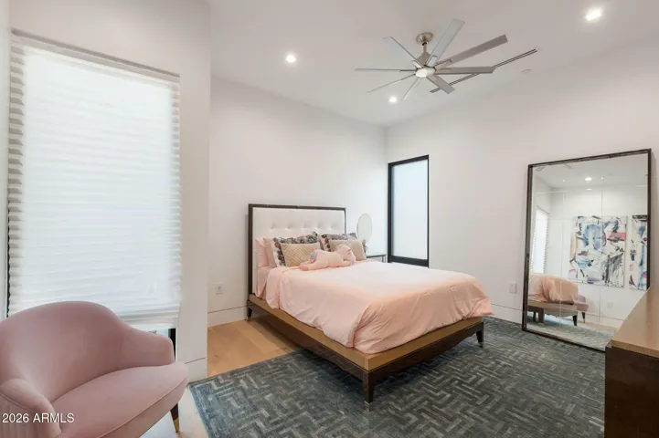 Comfortable secondary bedroom with soft natural light, modern finishes, and spacious layout. This Paradise Valley home offers well-designed guest or family living spaces.