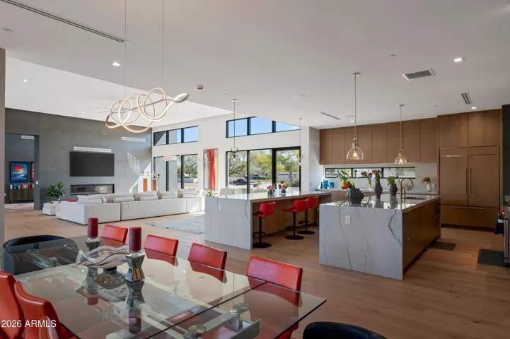 Open-concept kitchen flowing into the living area with large island, natural light, and modern finishes. This Paradise Valley home is perfect for entertaining.