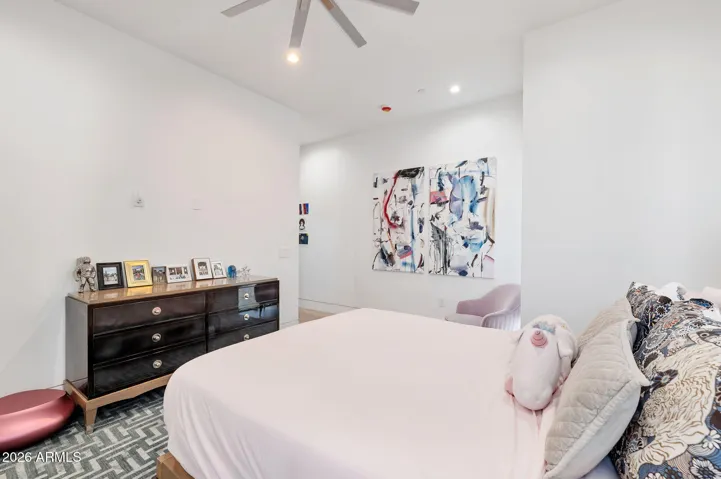 Secondary bedroom with large windows, modern flooring, and neutral tones. This Paradise Valley home offers bright and inviting guest accommodations.
