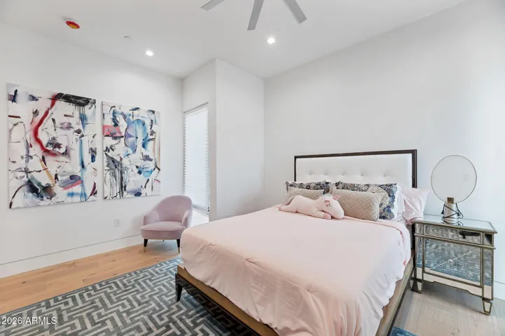 Well-appointed bedroom with modern décor, ample space, and natural light. This Paradise Valley home blends comfort with contemporary design.