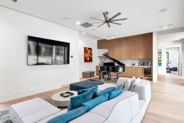 Contemporary living room with open layout, built-in cabinetry, and large wall for media display. This Paradise Valley home features modern finishes, natural light, and seamless flow for entertaining.