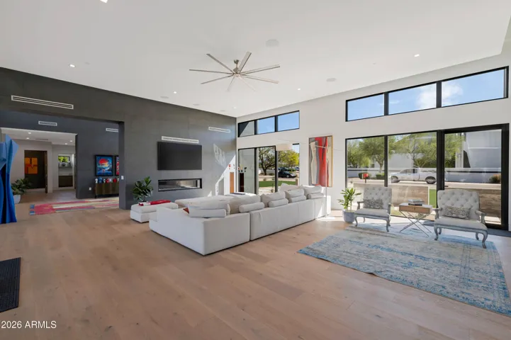 Expansive living room with soaring ceilings, large windows, and abundant natural light. This Paradise Valley home offers seamless indoor-outdoor living and modern architectural design.