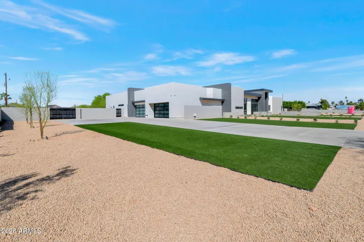 Large side yard with desert landscaping and perimeter wall for added privacy. This Paradise Valley property provides ample outdoor space with potential for customization and expansion.