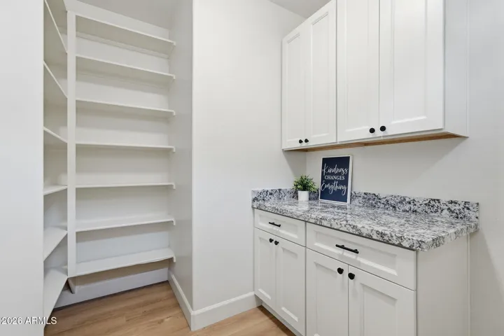 Spacious laundry room with pantry for maximum function and organization