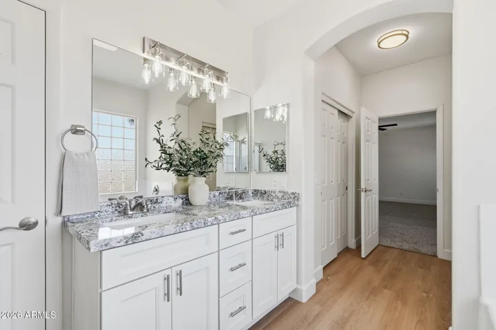 Primary bath with dual closets nearby and all-new finishes