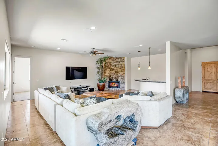Great room has built in wet bar and stone fireplace