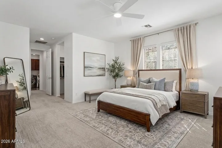 Spacious primary bedroom is split from secondary bedrooms (virtually staged)