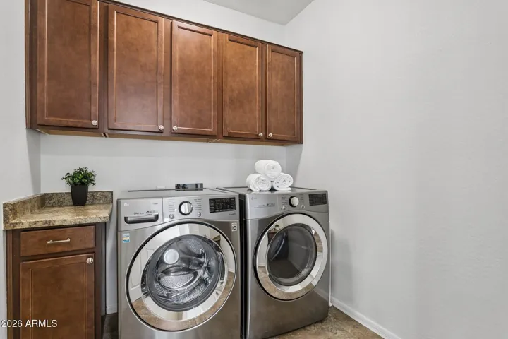 Laundry room has plentiful storage, two folding counters, LG stainless steel front load appliances