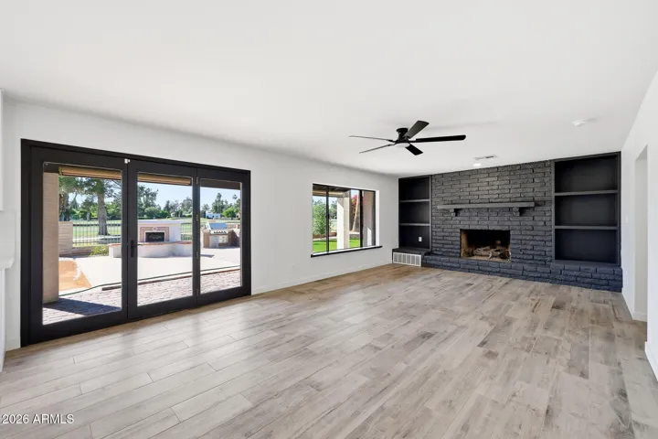 Living room with fire place. Golf course view included.