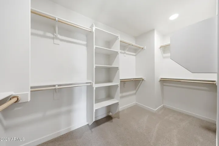Spacious primary walk-in closet.