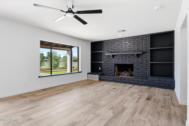 Living room with fire place. Golf course view included.