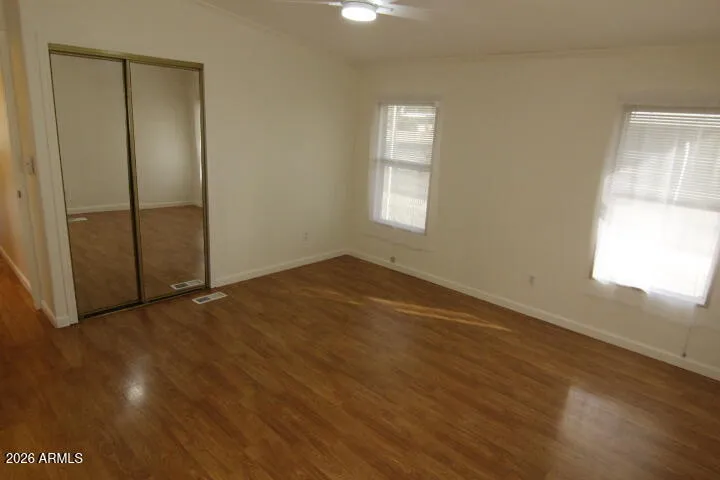 mirrored closet doors on a 2nd closet space in primary bedroom
