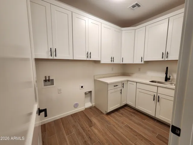 LARGE LAUNDRY ROOM WITH DEEP SINK. PICTURE IS OF A PREVIOUSLY BUILT SPEC.