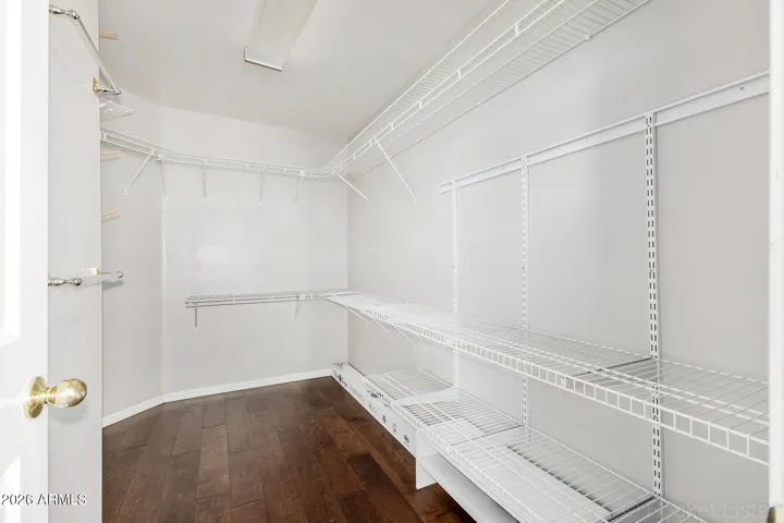 Primary bedroom walk in closet