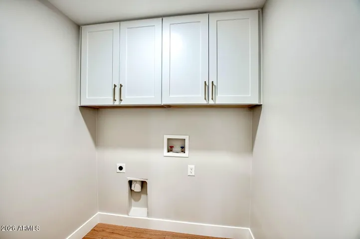 Laundry with built in cabinets.
