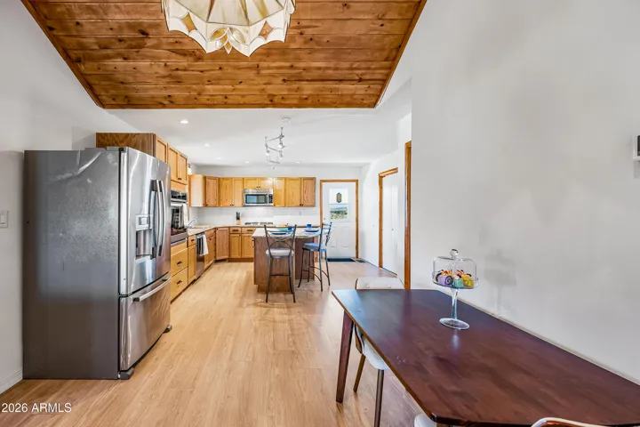 This space is large for a full table and china cabinet. Staged differently.