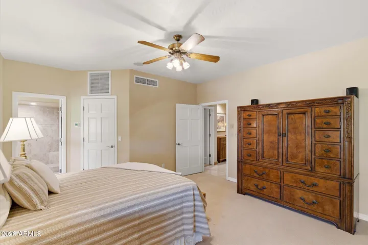 Has a large walk-in closet, luxurious bathroom with access to back patio and pool area.