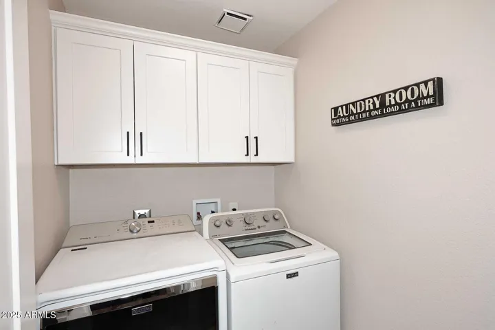 Inside laundry with storage