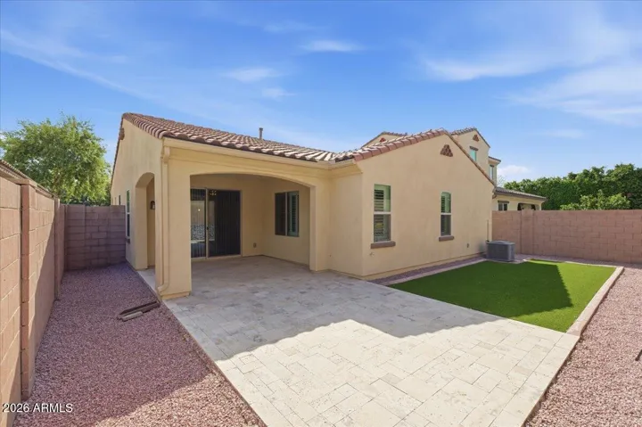Backyard extended patio and synthetic grass.
