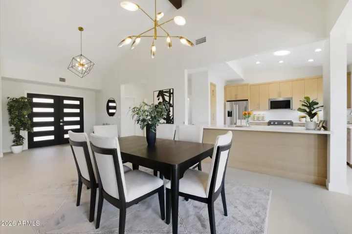 Inviting dining space with abundant natural light, adjacent to the kitchen, and offering easy access to the beautiful outdoor desert.