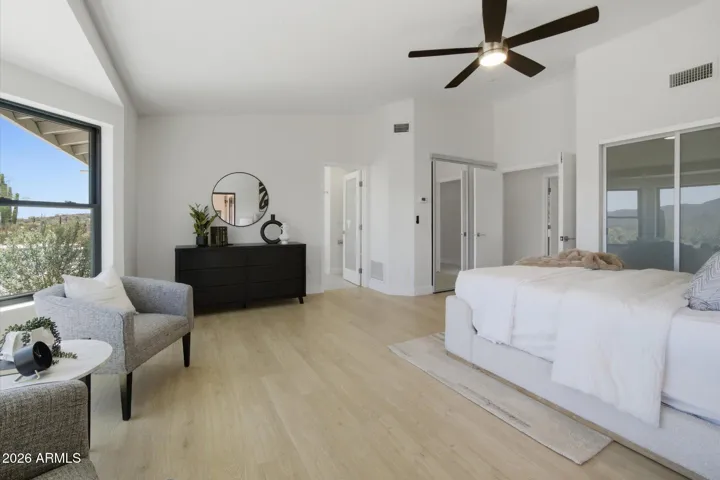 Generous primary bedroom with vaulted ceilings, featuring beautiful views and direct access to the en-suite.