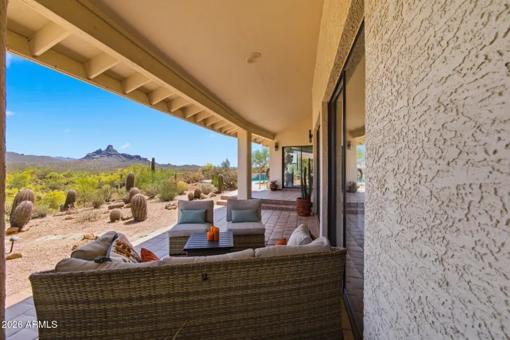 Generous covered patio providing ample space for outdoor living and enjoying the serene desert surroundings.
