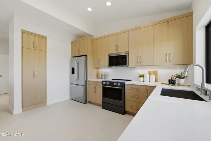 Well-appointed kitchen showcasing modern appliances, generous storage, and stylish finishes, designed for culinary enthusiasts.