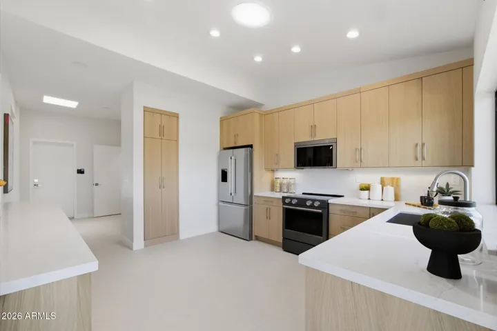 Radiant kitchen area with modern design elements, stainless steel appliances, and abundant natural light.