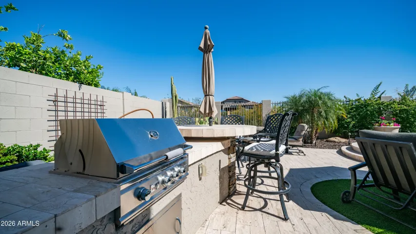 Custom Stone Paver Patio Anchors this Inviting Outdoor Kitchen