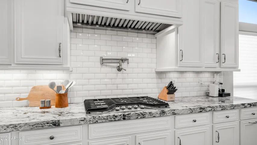 Culinary Focal Point with Gas Range and Tile Back Splash