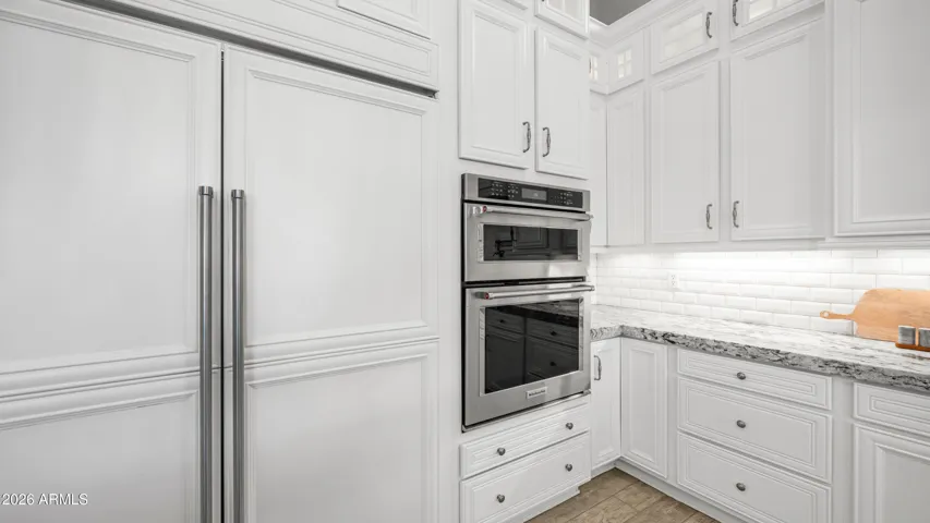 Rich Custom Cabinetry Paired with Expansive Prep and Serving Space