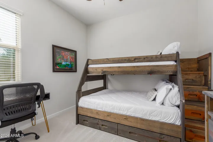 Flexible guest or office space with large window and natural light.