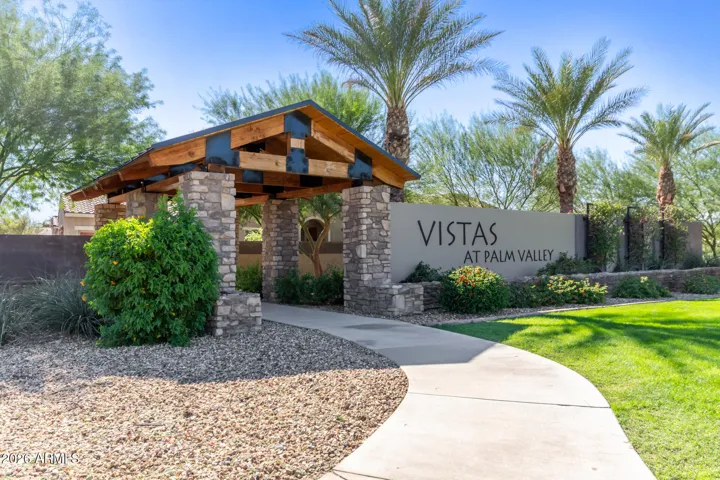 Welcome to Vistas at Palm Valley, a gated access surrounded by lush landscaping and palm-lined paths. Main Entrance - Enter from Palm Valley Blvd & 141st Ave.