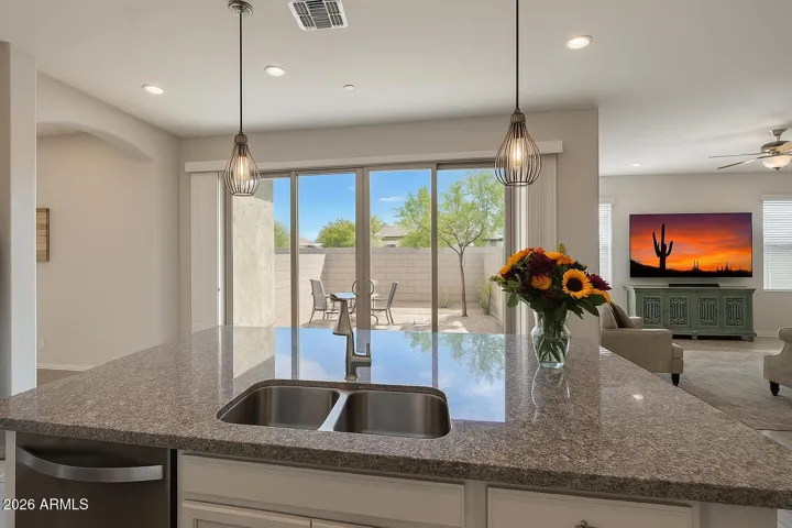 Double 8'ft sliders open from kitchen to private side patio - ideal for relaxing evenings.