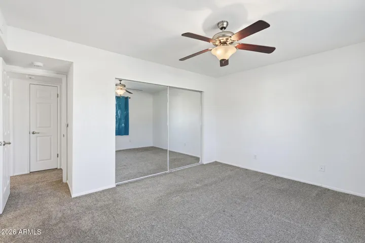 Spacious primary bedroom retreat offering comfort, privacy, and convenient access to the en-suite bathroom.