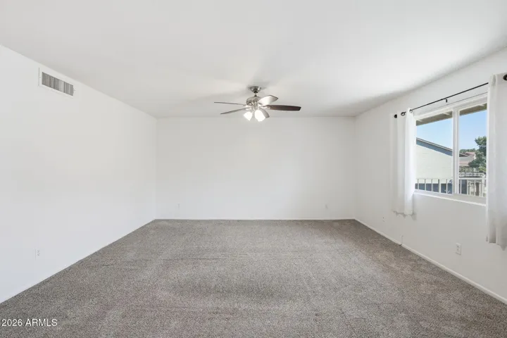 Bright and open living room in Scottsdale condo featuring a spacious layout ideal for relaxing or entertaining with seamless flow to the dining and kitchen areas.